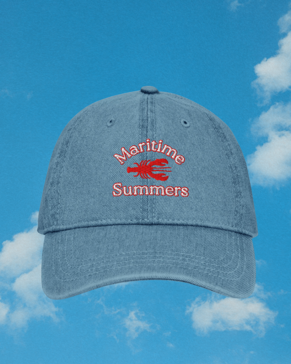 Maritime Summers lobster denim hat against blue summer sky